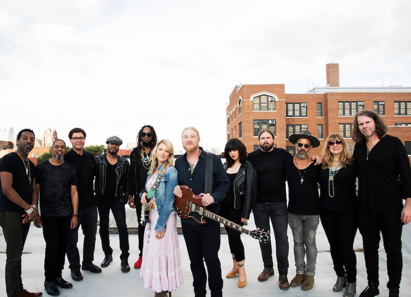 Susan Tedeschi and Derek Trucks of the Tedeschi Trucks Band pose with band members.