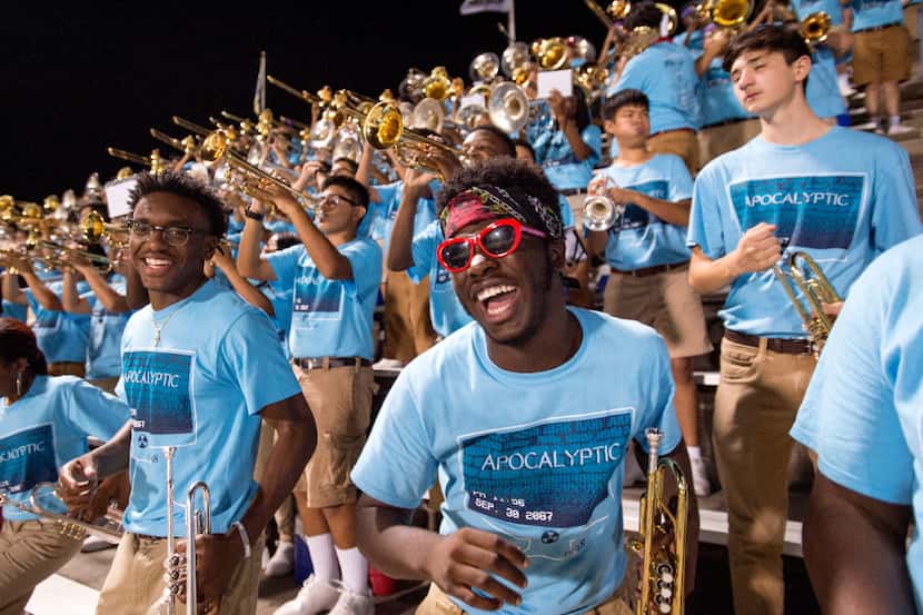 Duncanville sophomore trumpet player Mario Roman dances in the stands during the second half...