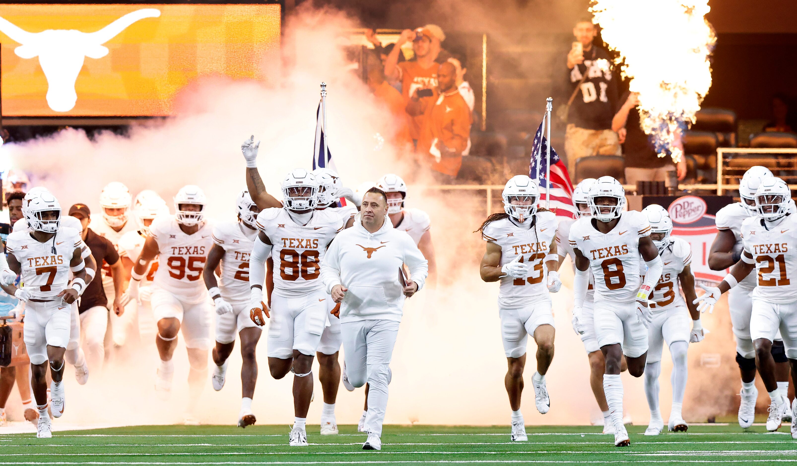 The Texas Longhorns football team races onto the field during team introductions before the...