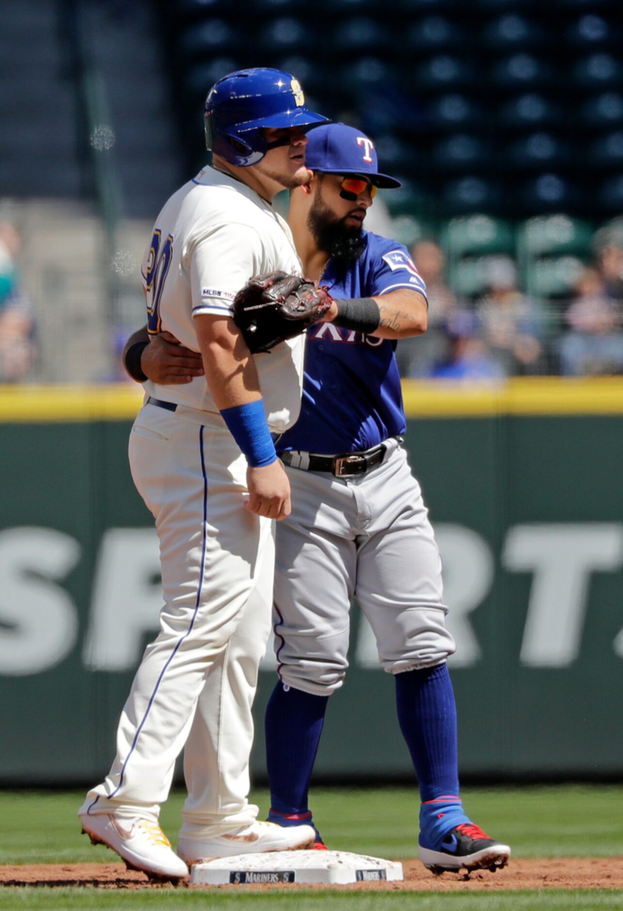 Texas Rangers second baseman Rougned Odor, right, embraces Seattle Mariners' Daniel...