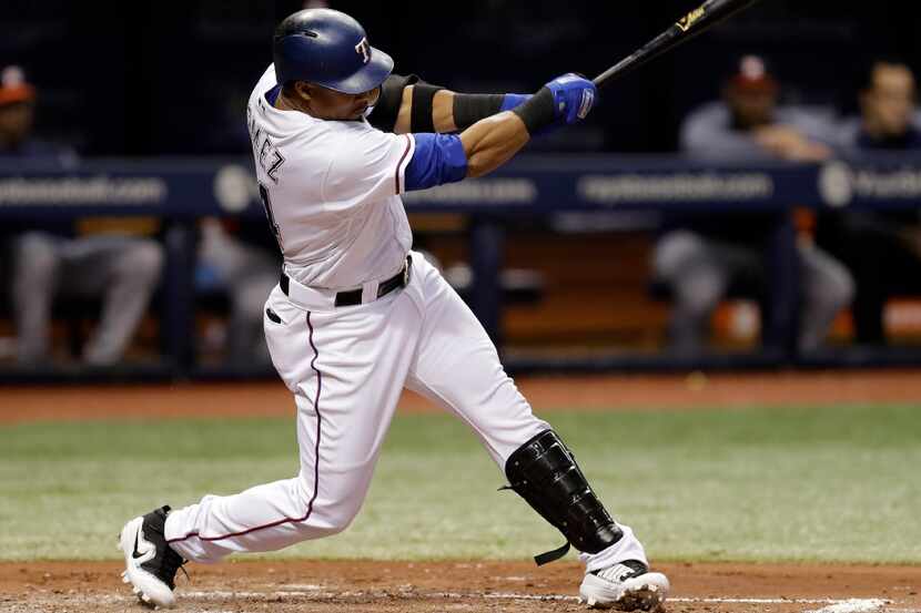 Texas Rangers' Carlos Gomez lines a two-run single off Houston Astros starting pitcher...