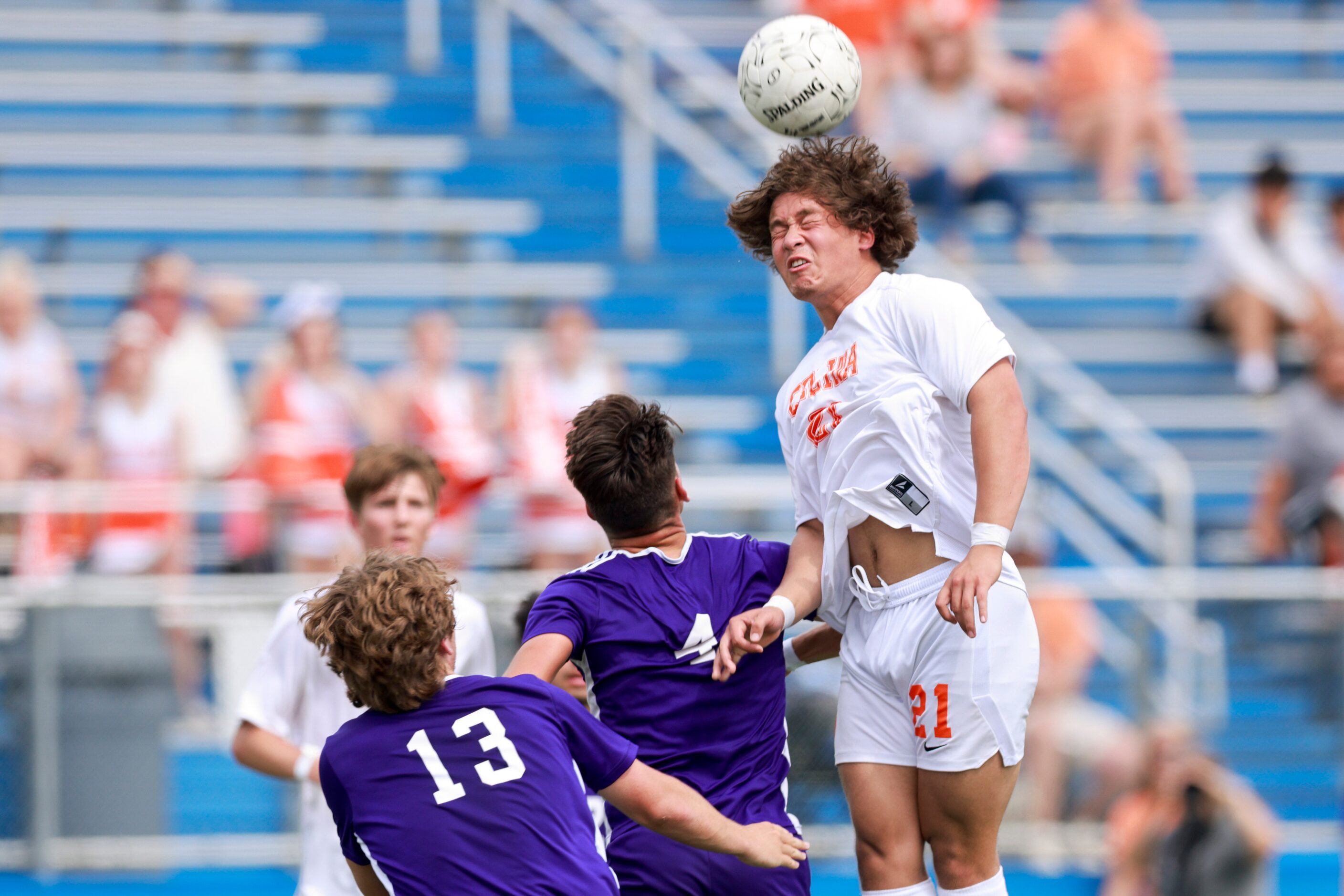 Celina forward Troy Peterson (21) heads the ball over Boerne midfielder Landon Murphy (4)...