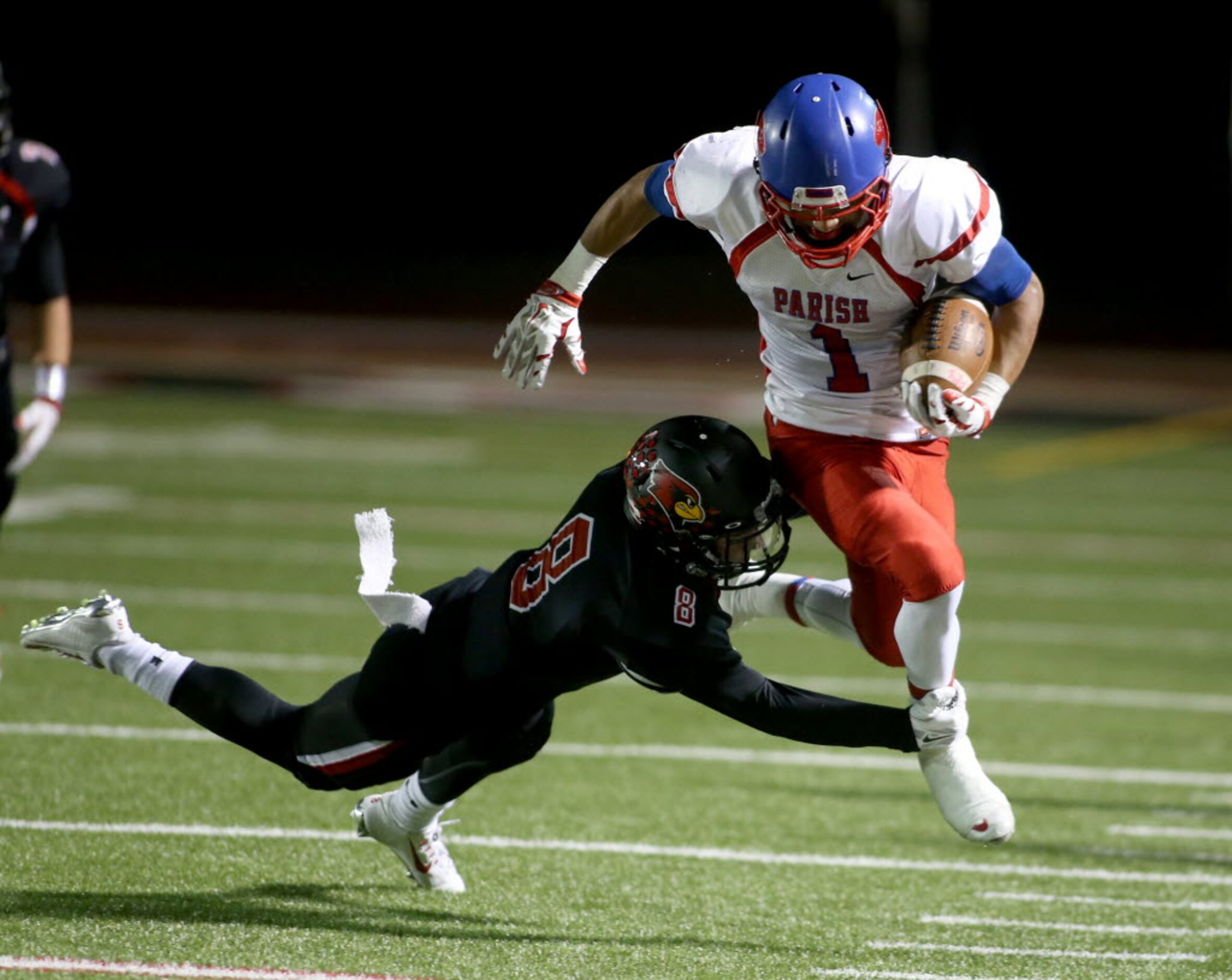 Parish Episcopal’s Xavier Suggs (1) is tackled by Fort Worth Christian’s Blake Garcia (8)...