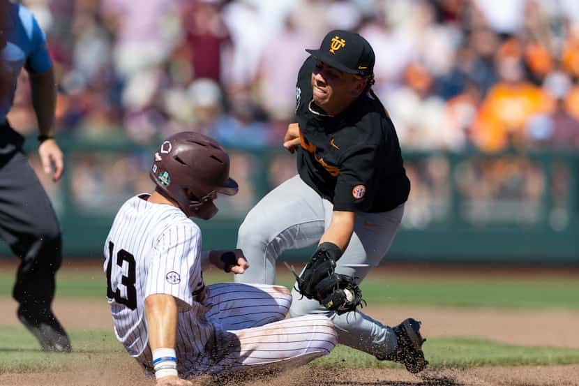 Tennessee's Ariel Antigua, right, reaches to tag out Texas A&M's Caden Sorrell between first...