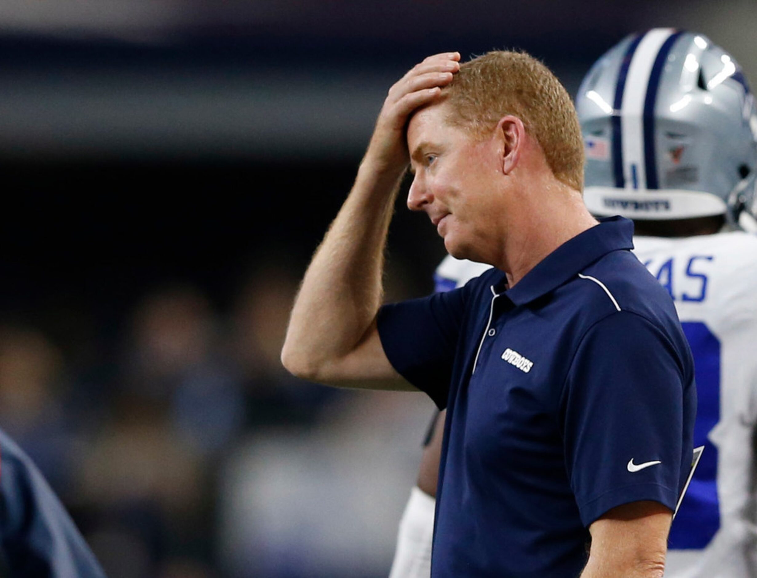 Dallas Cowboys head coach Jason Garrett rubs his head after the defense was called for pass...