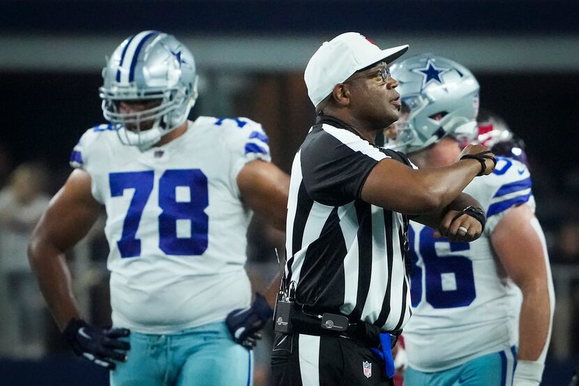 Referee Ron Torbert signals a false start against Dallas Cowboys offensive tackle Terence...