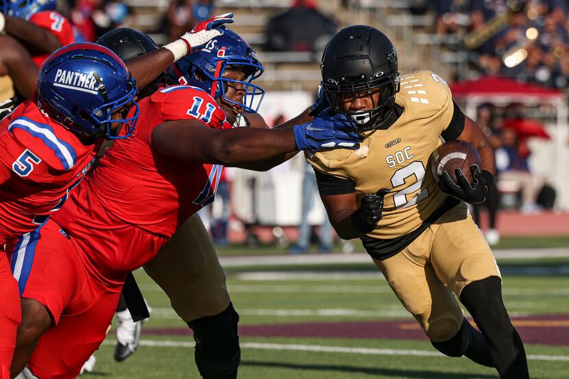 Duncanville defenders try to bring down South Oak Cliff running back Tedrick Williams...