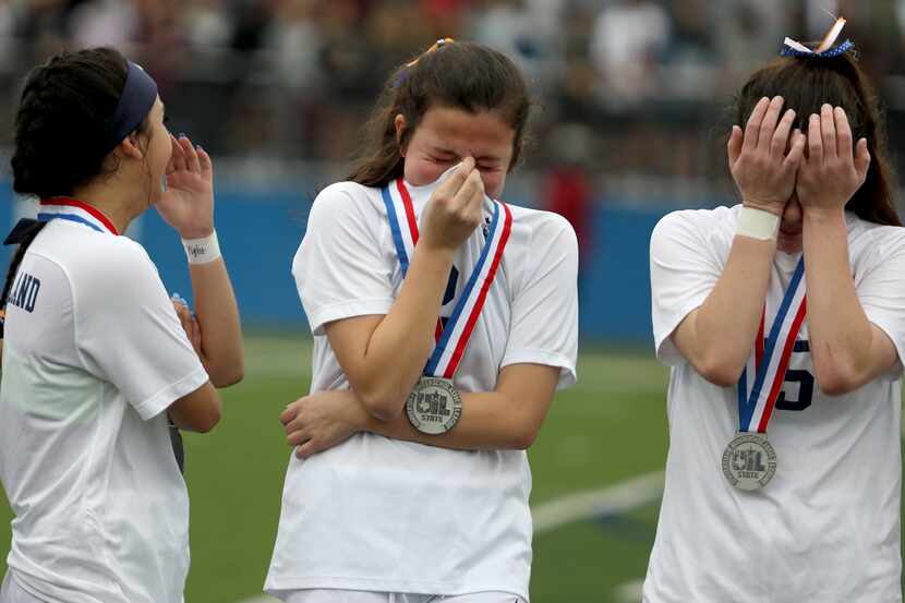 Wakeland's Natalie Cox (from left), Rachel Perry, and Ally Perry react after their UIL 5A...
