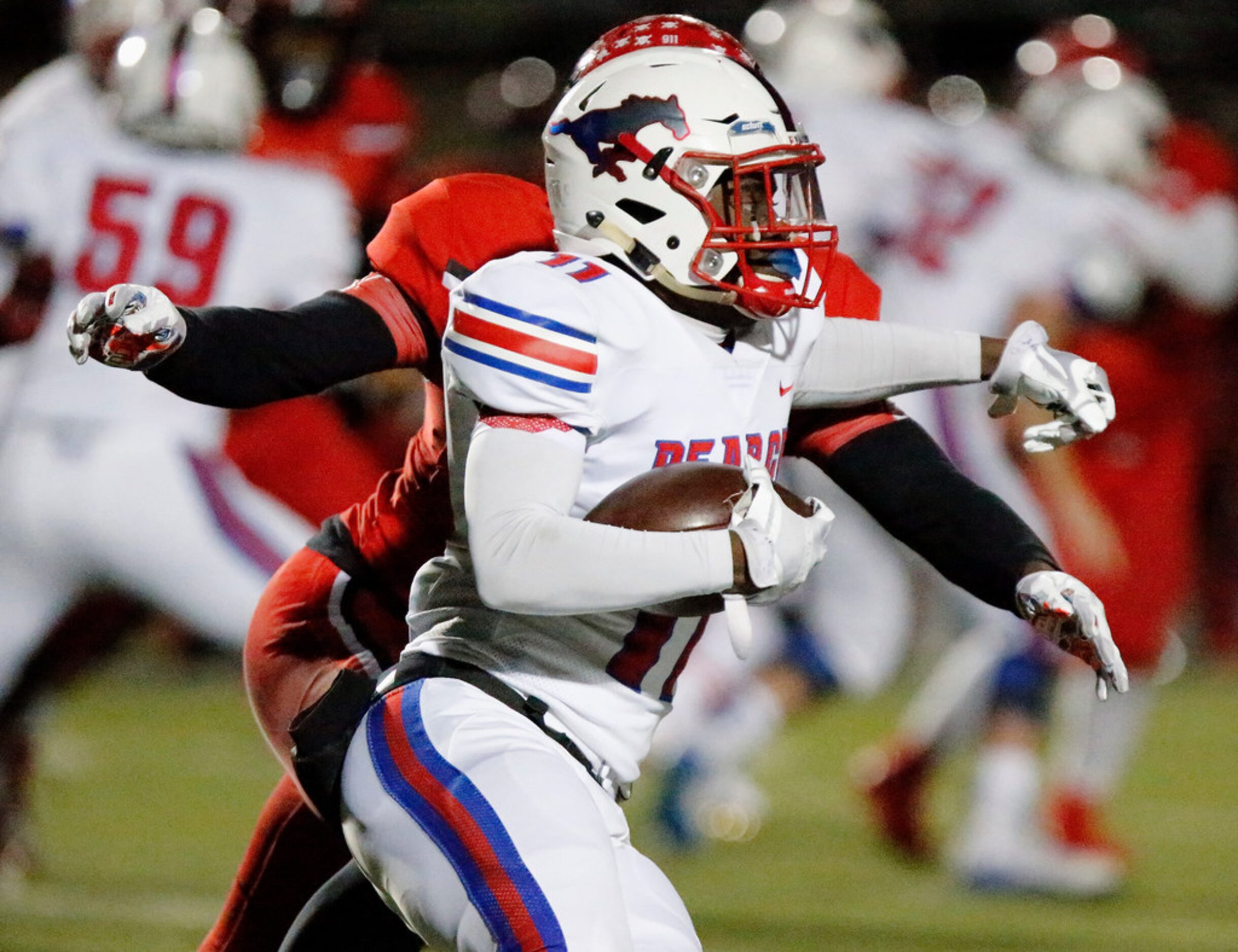 Pearce High School wide receiver Lededrick Oliver (11) tries to escape the grasp of Cedar...