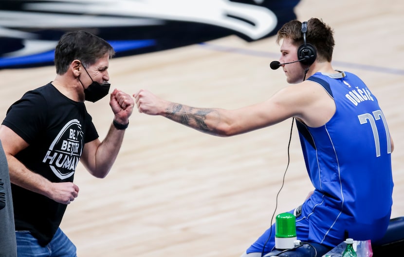 Dallas Mavericks owner Mark Cuban fist bumps guard Luka Doncic (77) after a 118-117 win over...