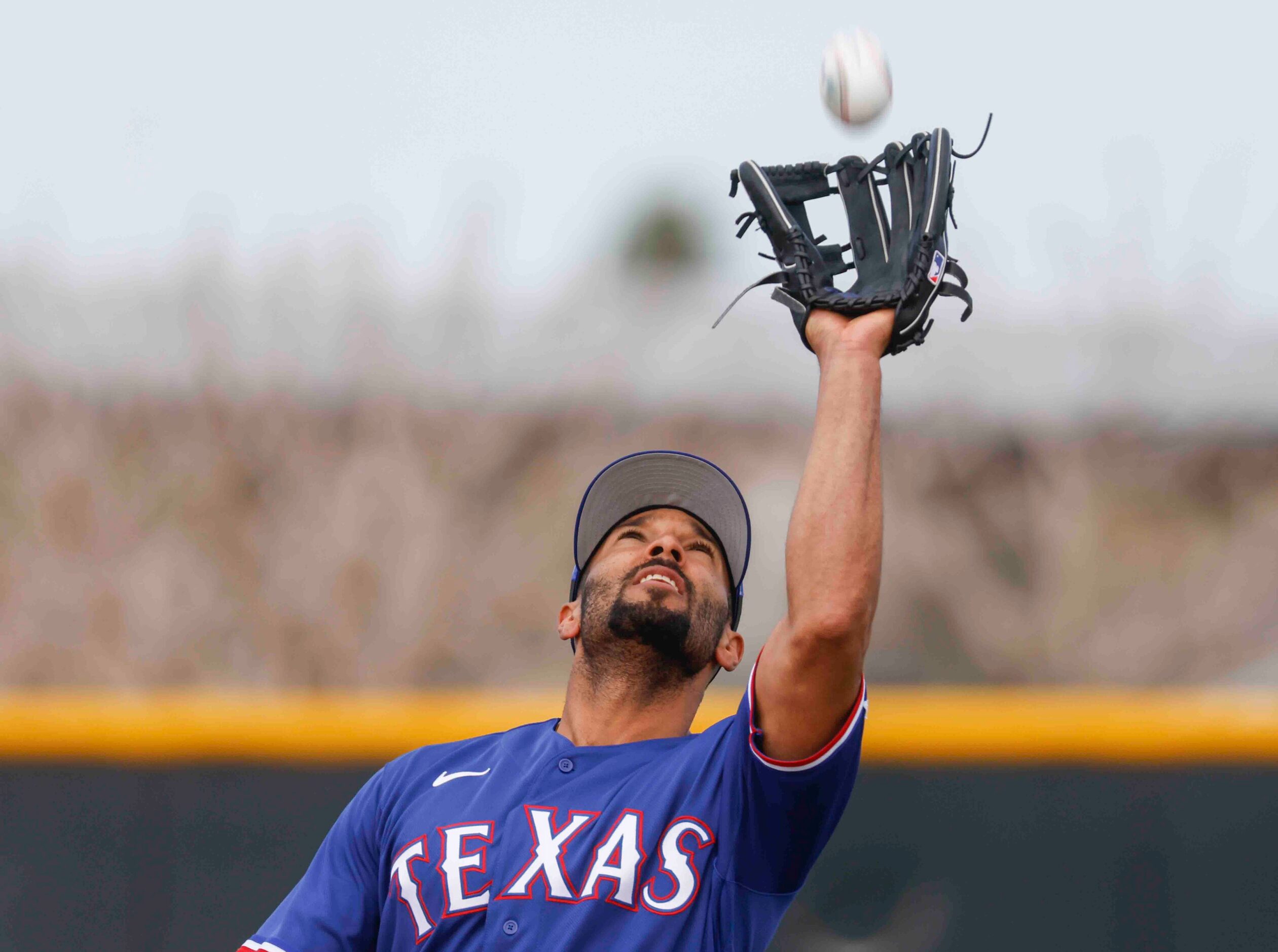 Texas Rangers infielder Marcus Semien makes a catch during a spring training workout at the...