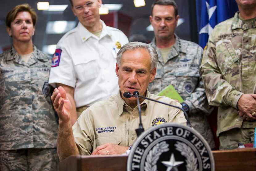 Gov. Greg Abbott answers questions following a briefing to the public on Hurricane Harvey at...
