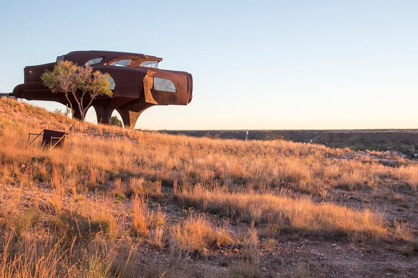 The sun sets on Robert Bruno's Steel House in Ransom Canyon, a residential community east of...