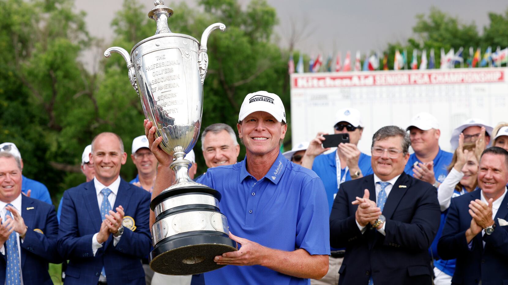 Steve Stricker of the United States raises the Bourne Trophy after winning the KitchenAid...