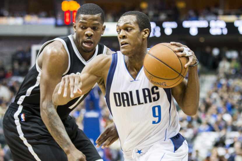 Dallas Mavericks guard Rajon Rondo (9) escapes form Brooklyn Nets forward Joe Johnson (7)...