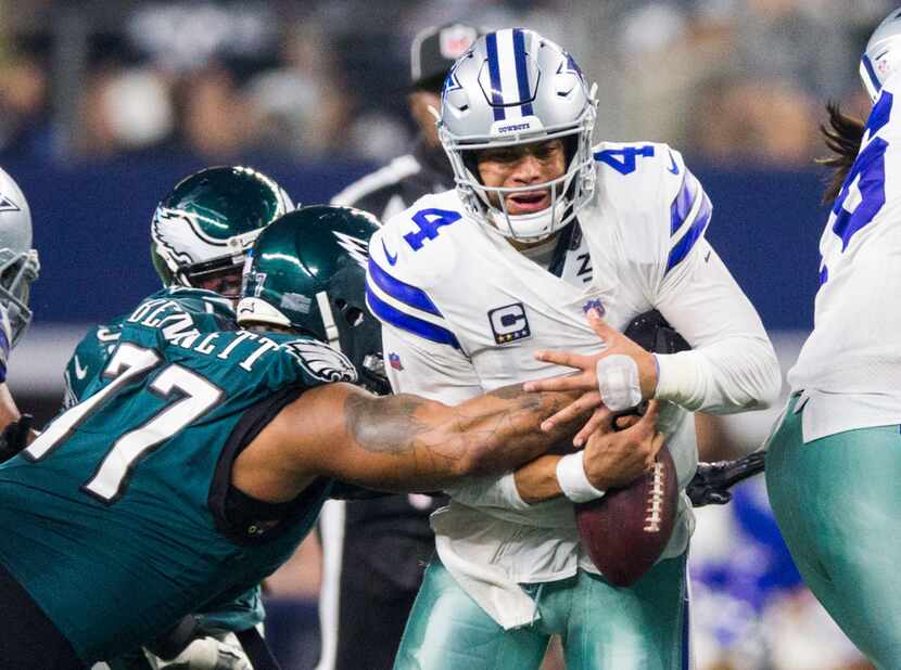 Cowboys quarterback Dak Prescott (4) fumbles the ball as he's hit by Philadelphia Eagles...