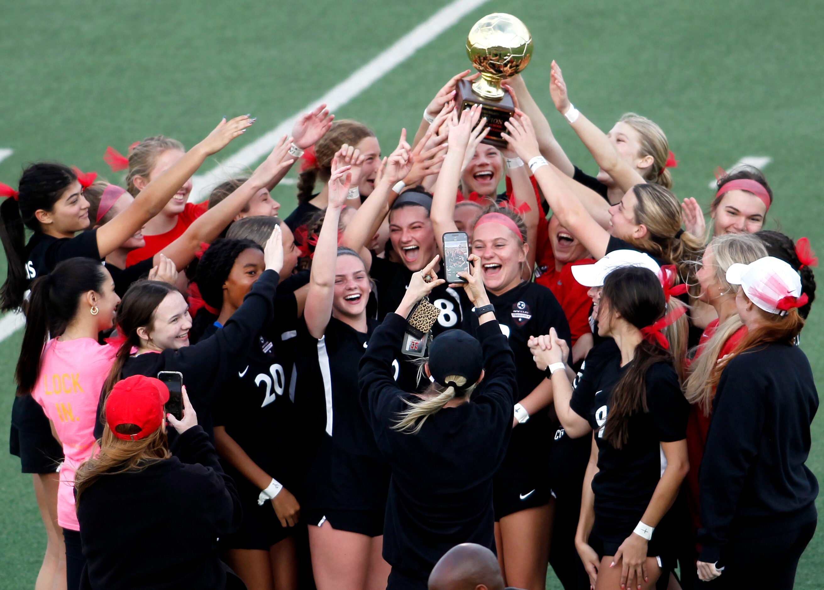 Flower Mound Marcus players revel in the moment as they celebrate after being presented the...