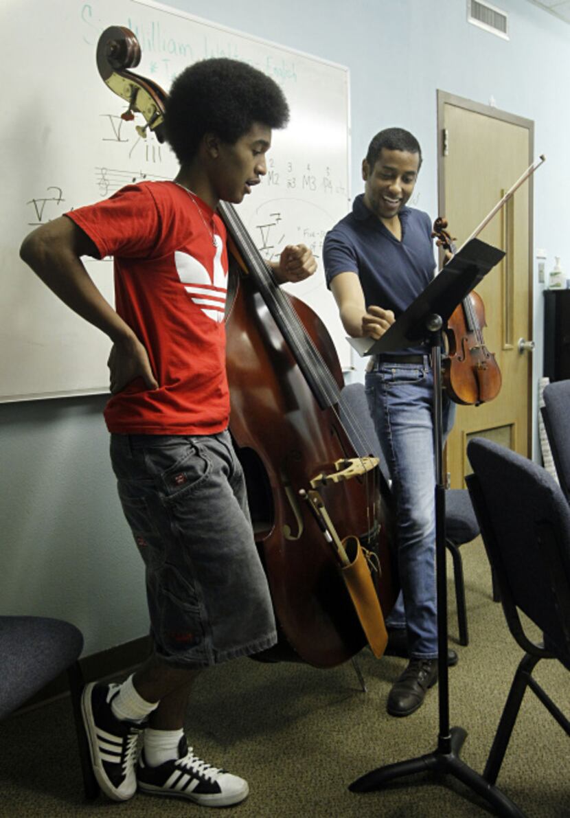 Marcus Pyle, a 23-year-old Juilliard student from Garland (right), helps bass player Daniel...