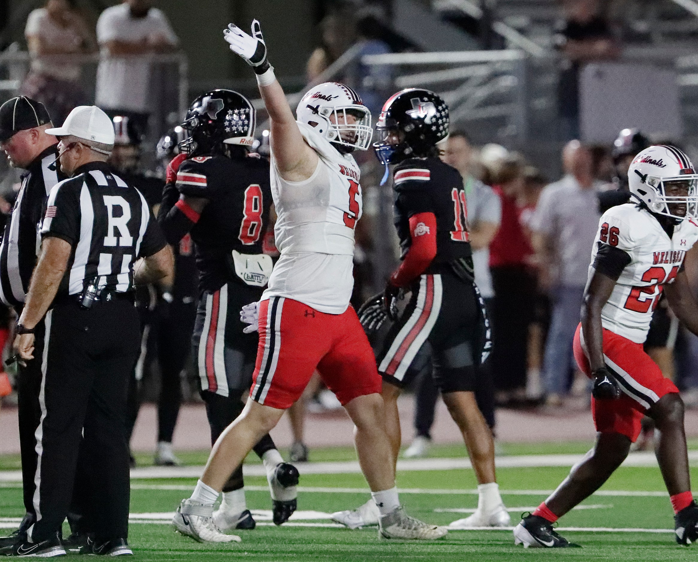 Melissa High School defensive lineman Jacob Wasserman (5) signals a recovered fumble by the...