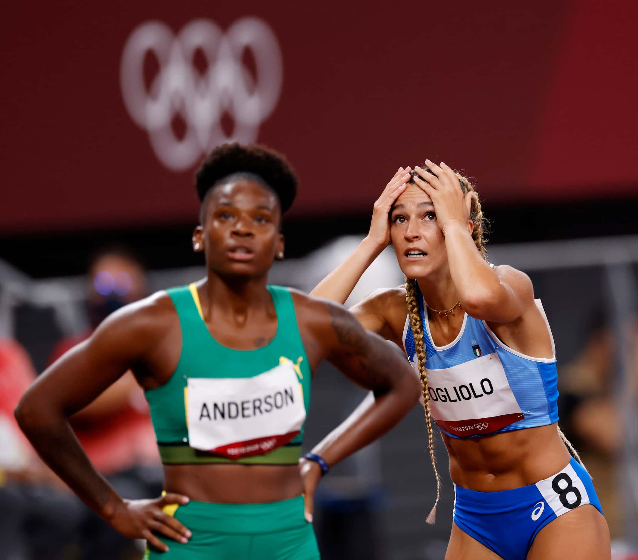 Italy’s Luminosa Bogliolo reacts after seeing her final time of 12.75 seconds in the women’s...