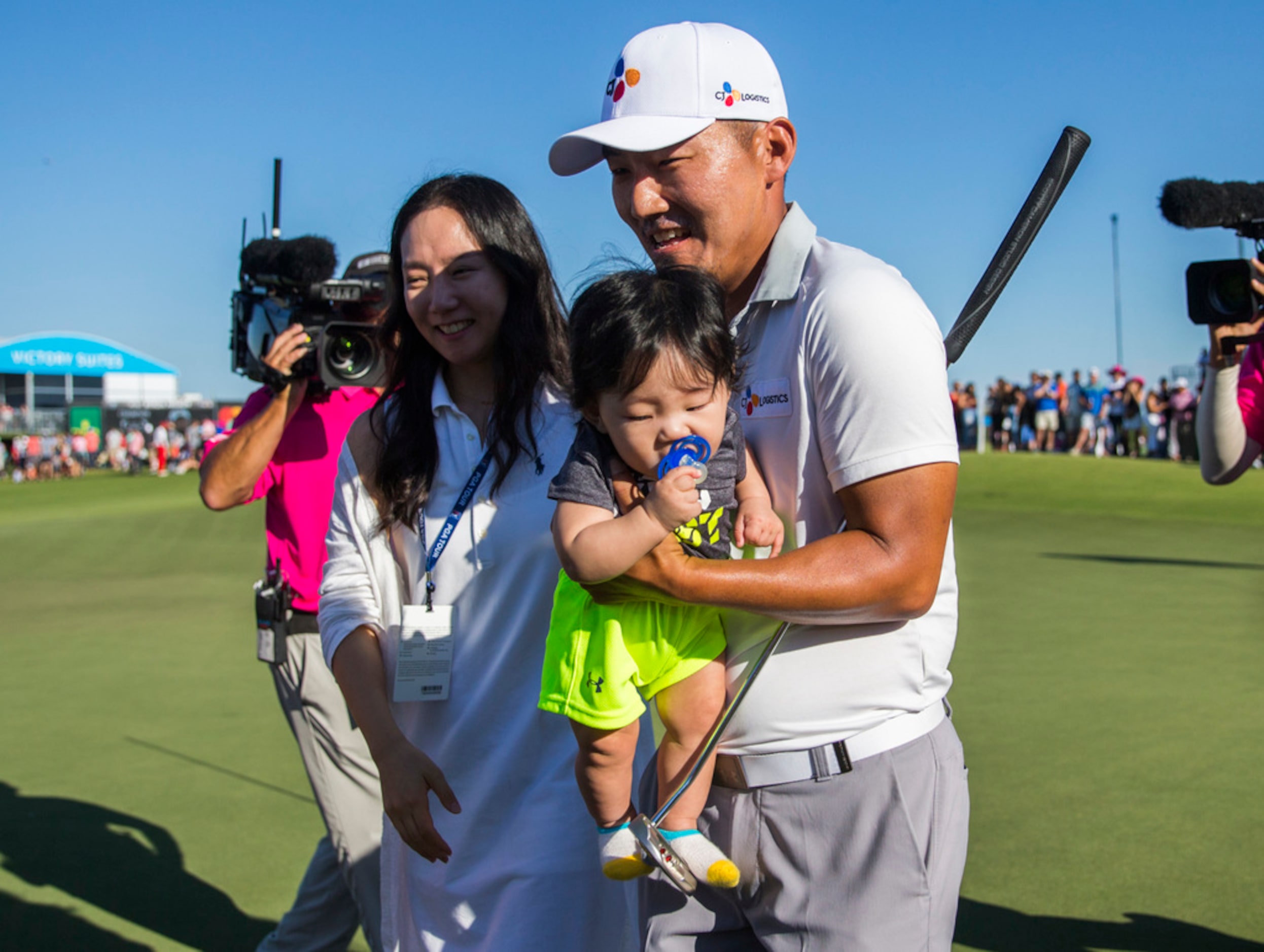 Sung Kang (right), his wife, So Young Kang, and son, Eugene Kang, 7 mo., celebrate after he...