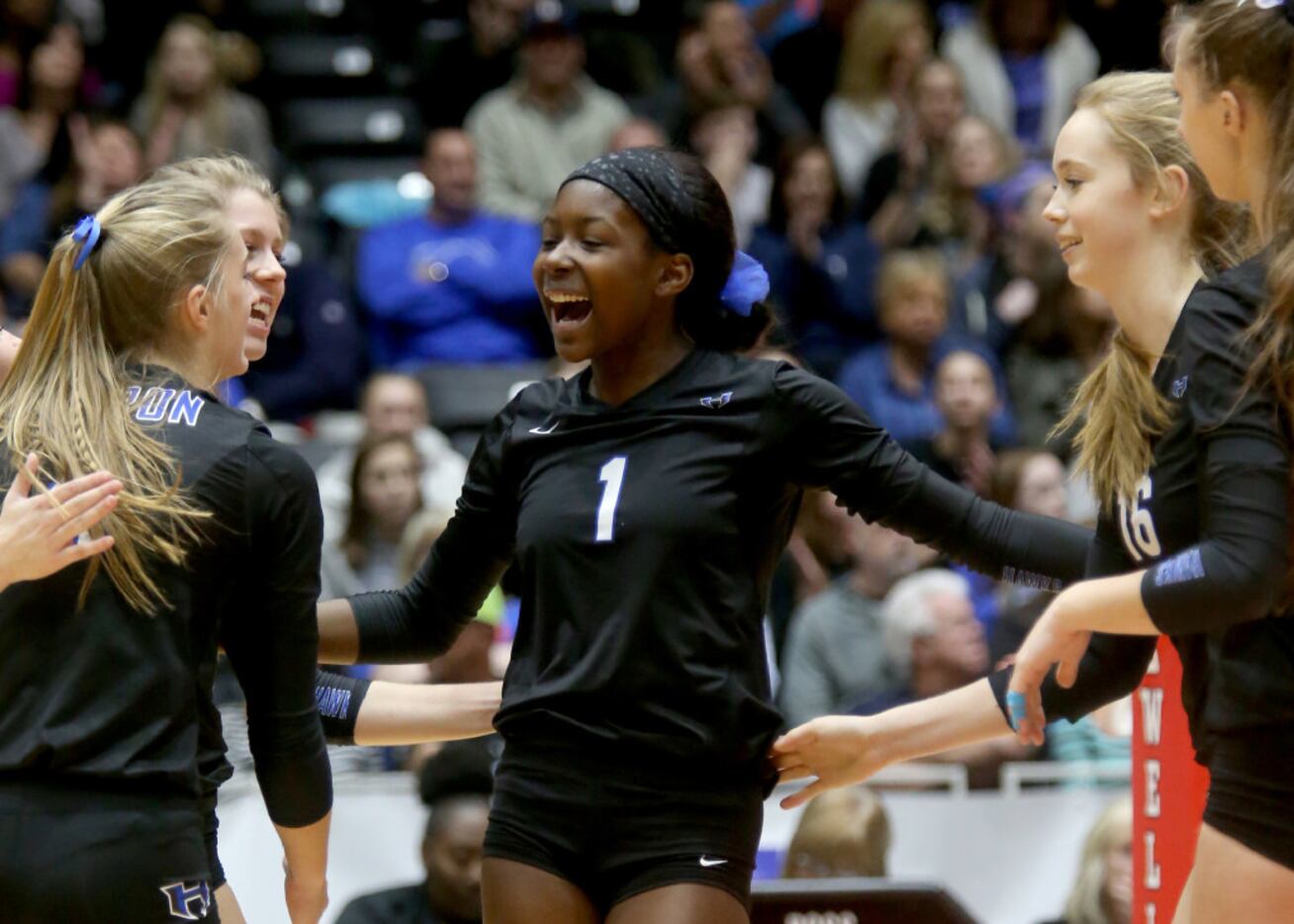 Hebron's Adanna Rollins (1) is all smiles after a ace in Class 6A Volleyball State...