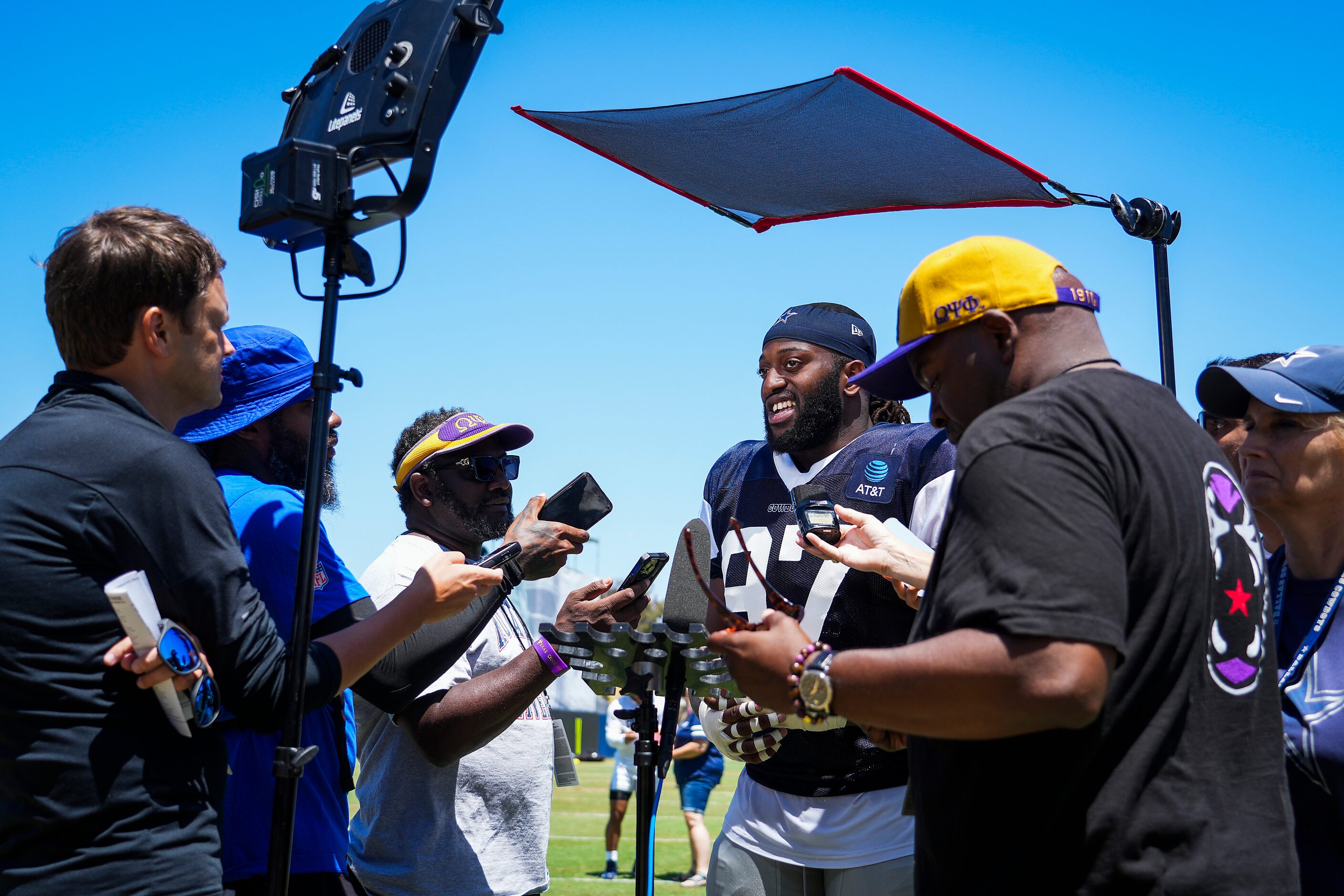 Dallas Cowboys defensive tackle Osa Odighizuwa talks with reporters following a training...