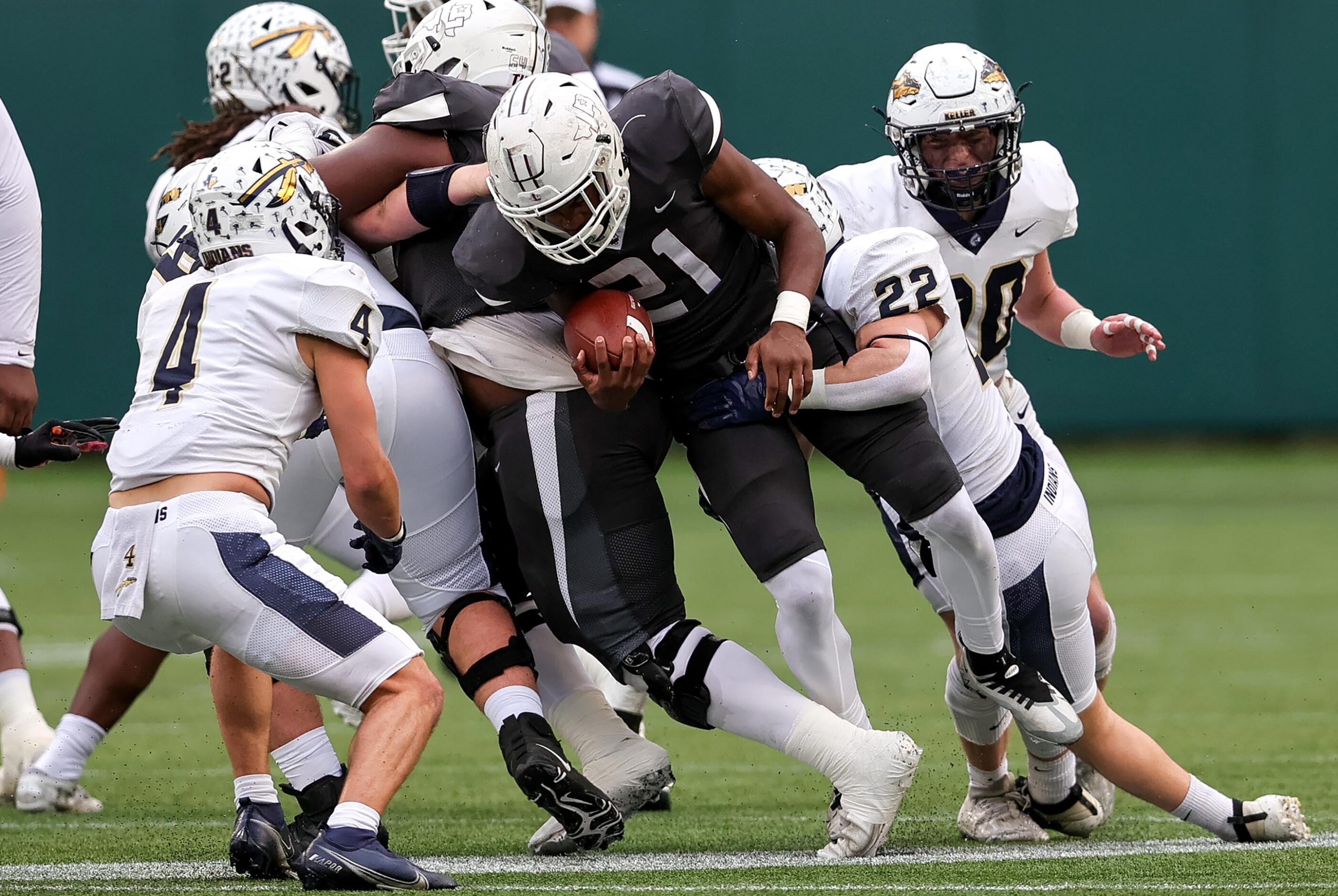 Lewisville running back Viron Ellison (21) is stopped for a short gain by Keller linebacker...