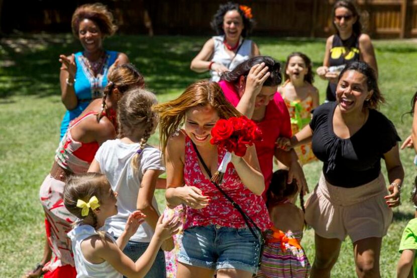 
Aline Roskam of Rockwall caught a bouquet thrown at a traditional Brazilian post-Carnivale...