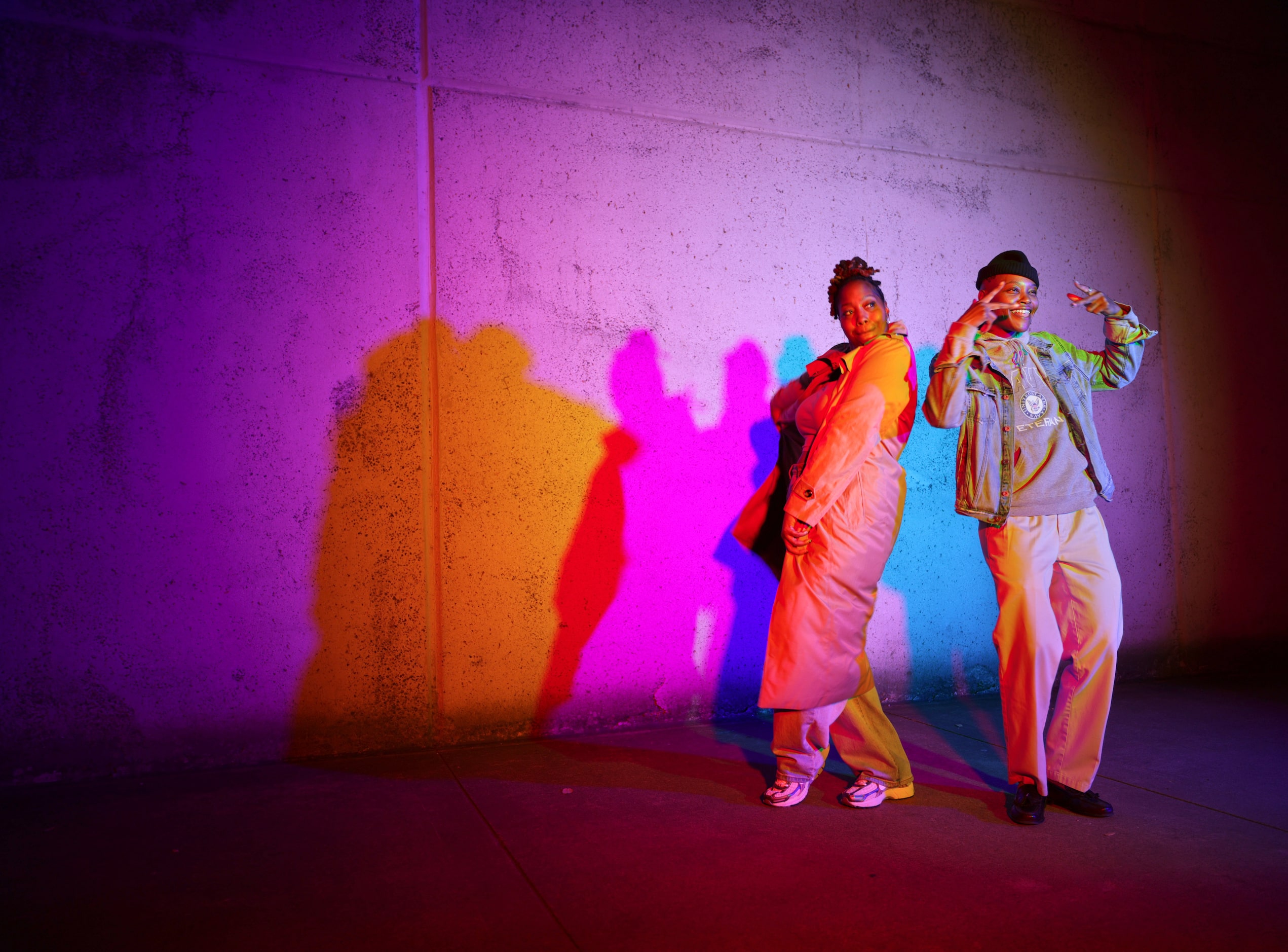 Aundrea Dorsey, left, and Shaq Michelle interact with a color wall during Aurora in downtown...