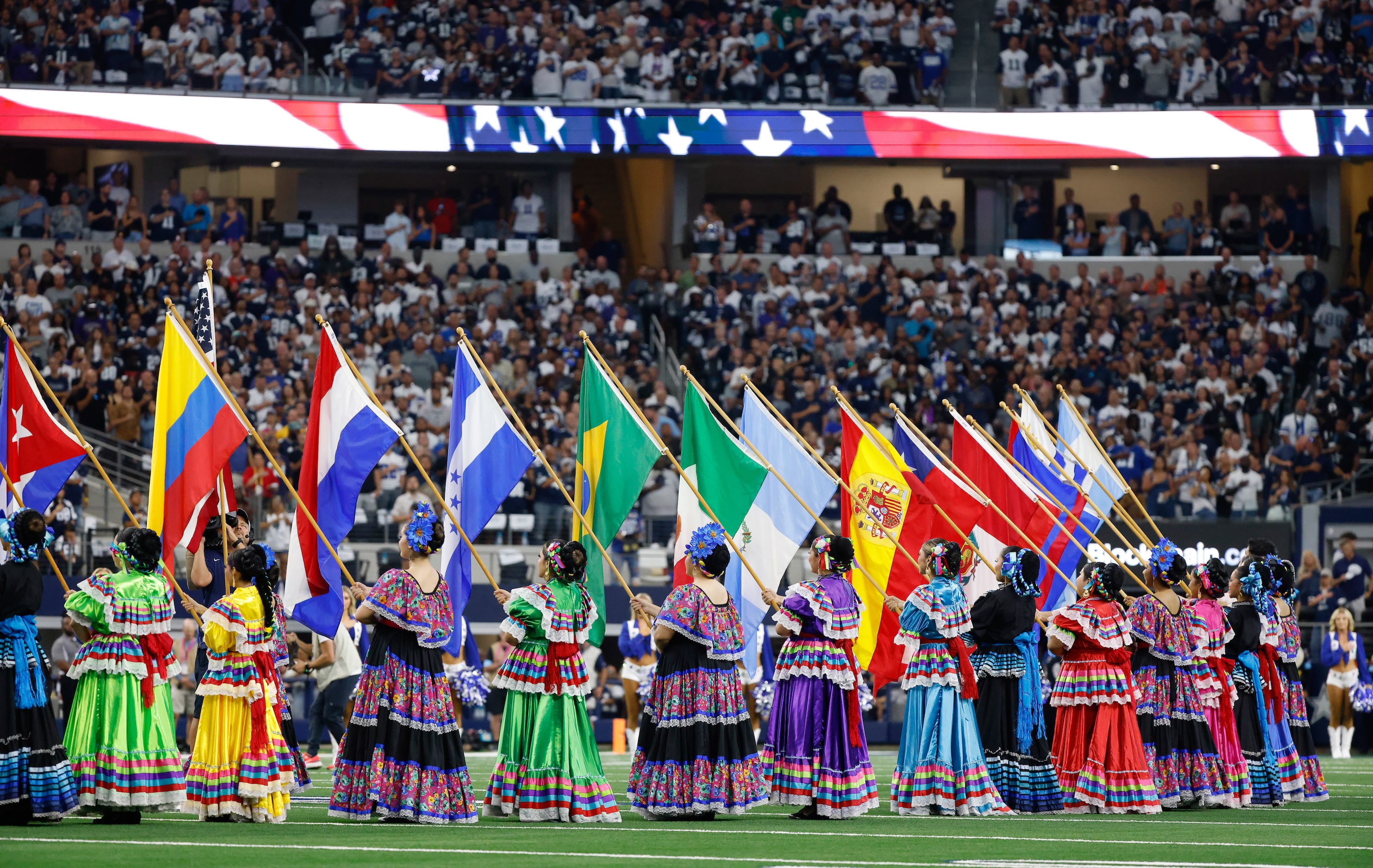 Folklorical dancers present the colors of Hispanic countries during the playing of the...