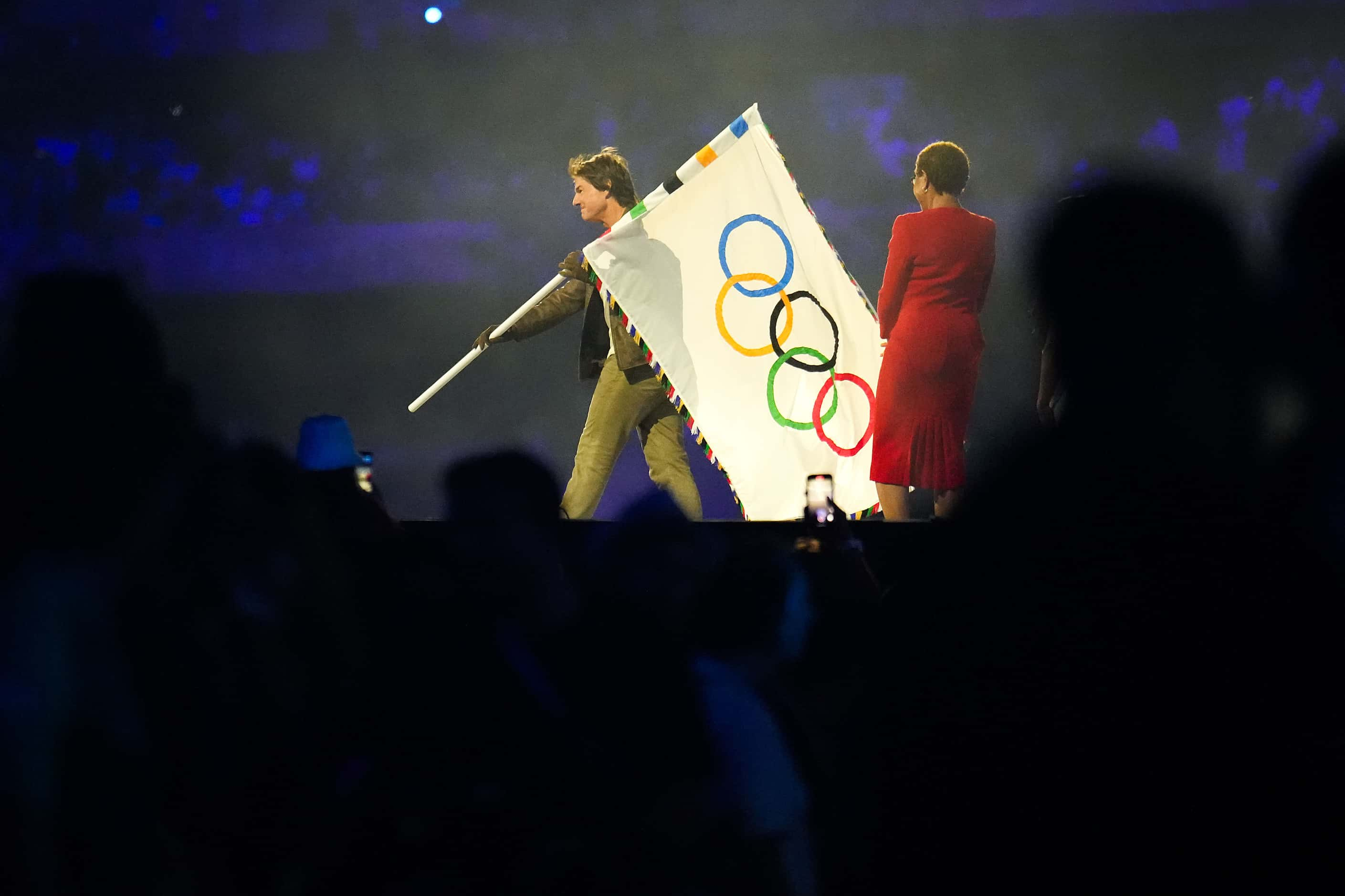 Actor Tom Cruise takes the Olympic flag from Los Angeles mayor Karen Bass during closing...