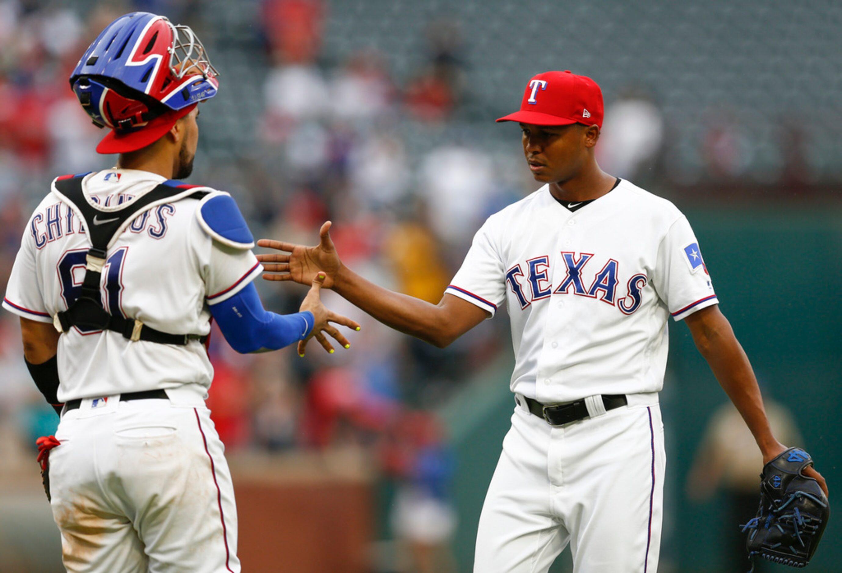 Texas Rangers relief pitcher Jose Leclerc, right, and catcher Robinson Chirinos (61)...