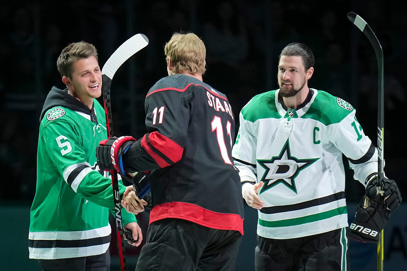 Texas Rangers shortstop Corey Seager shakes hands with Carolina Hurricanes center Jordan...