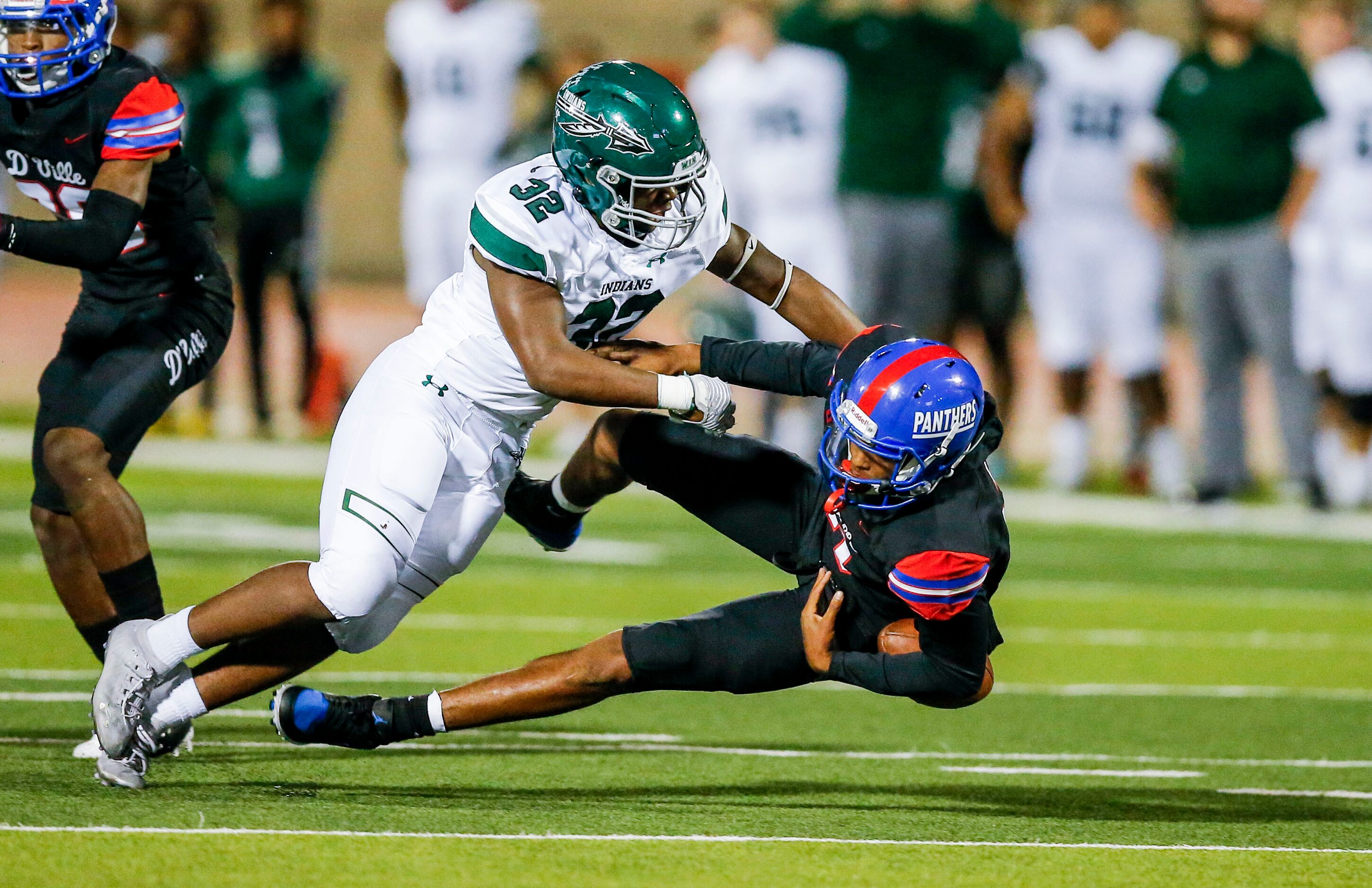 Waxahachie junior linebacker La’Markus Reed (32) tackles Duncanville senior quarterback...