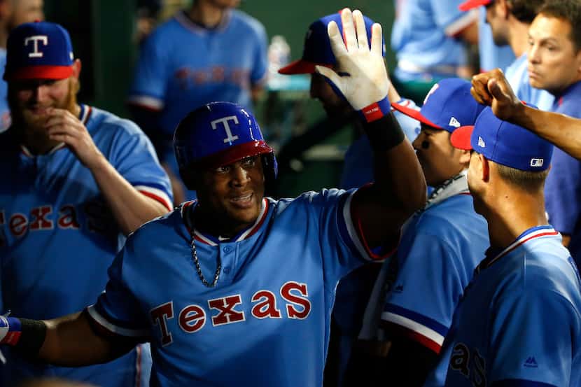 Texas Rangers third baseman Adrian Beltre (29) is congratulated by teammates for his two-run...