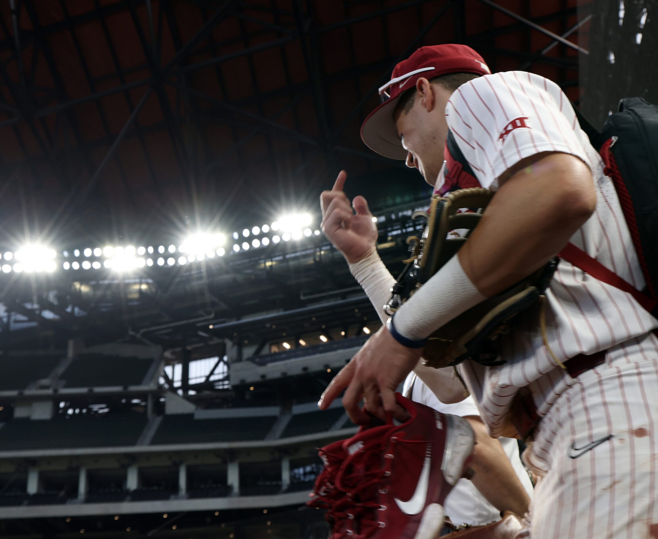 Oklahoma Sooners first baseman Blake Robertson (26) leaves the team dugout sporting a smile...