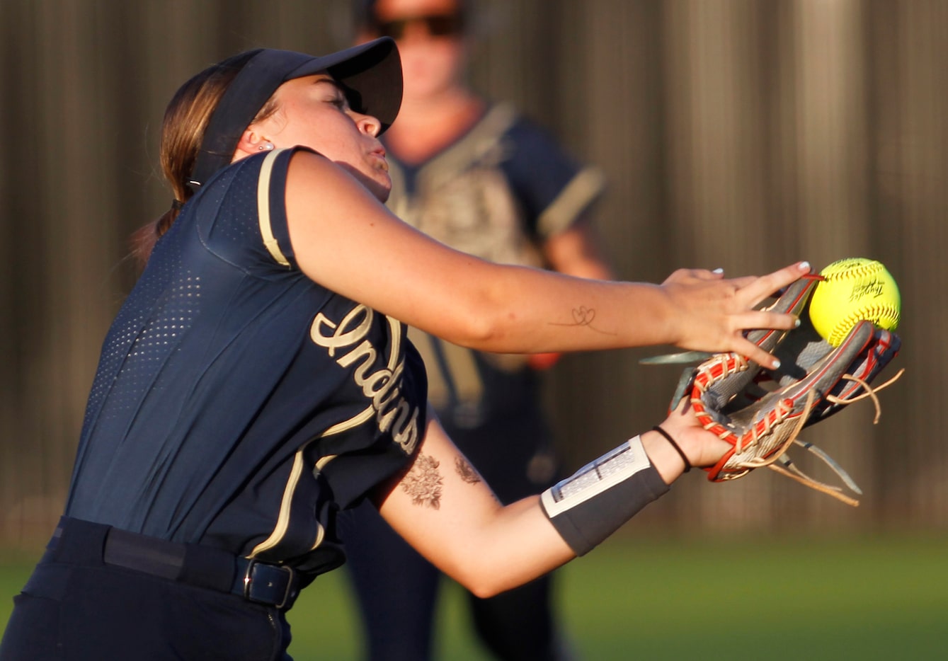 Keller Indians third baseman Landry Beaman (6) pulls in a high fly ball during the bottom of...