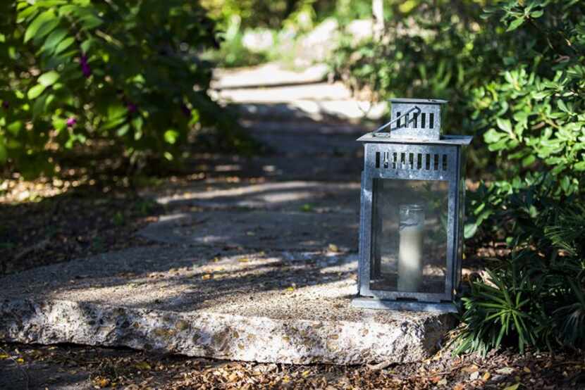 
A candle lantern lines the front walkway in the Boyd-Lloyds’ garden.
