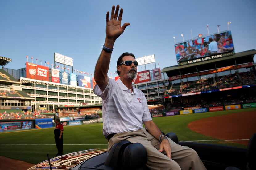 Former baseball player Jeff Russell waves to the crowd as he arrives for the Texas Rangers...