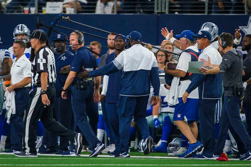 Dallas Cowboys head coach Jason Garrett glares as field judge Scott Edwards (3) after...