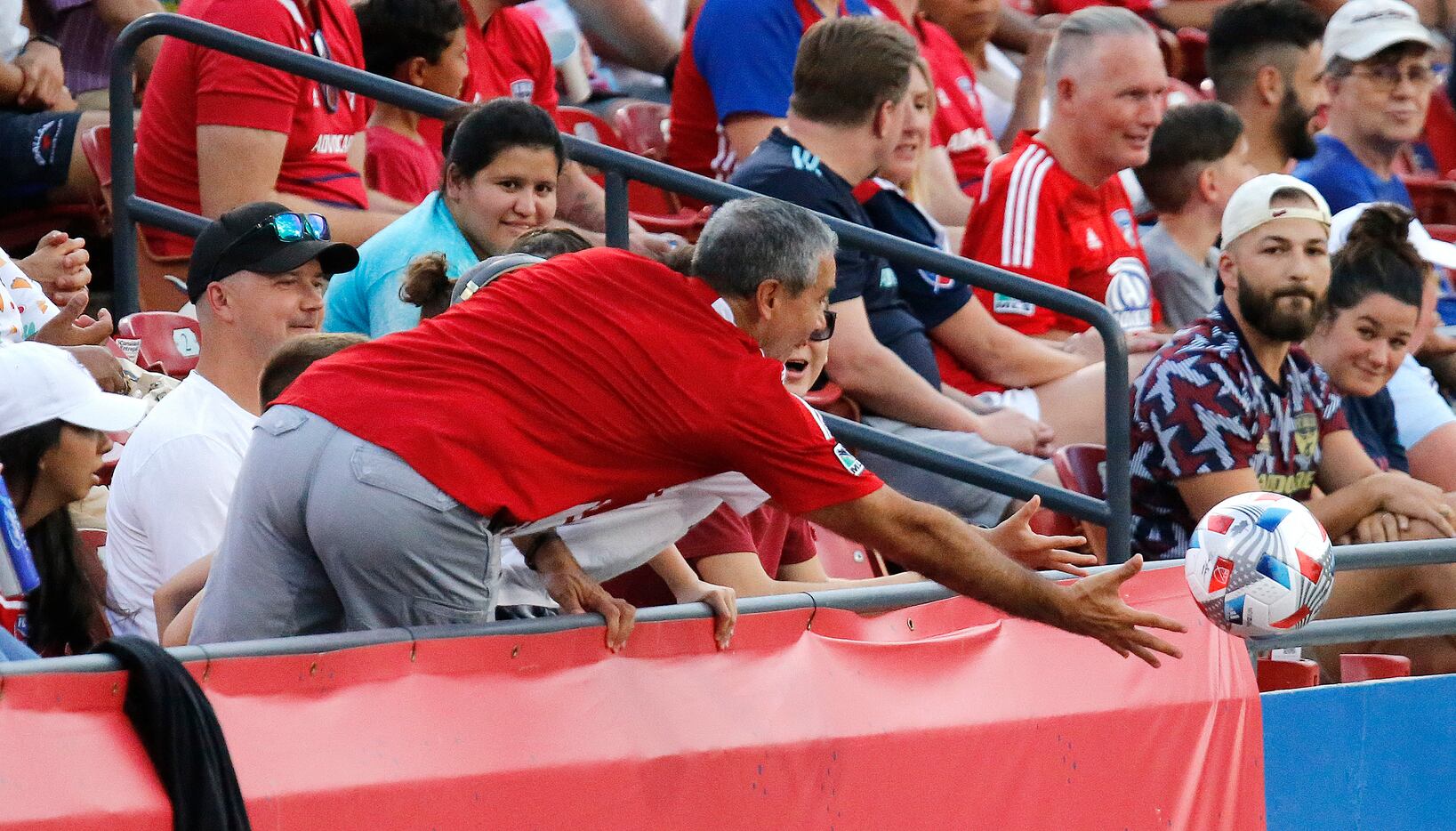 A fan attempts to snag a stray kick during the first half as FC Dallas hosted Sporting...