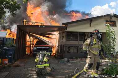 Fort Worth firefighters battled a two-story house fire Monday evening which left three...