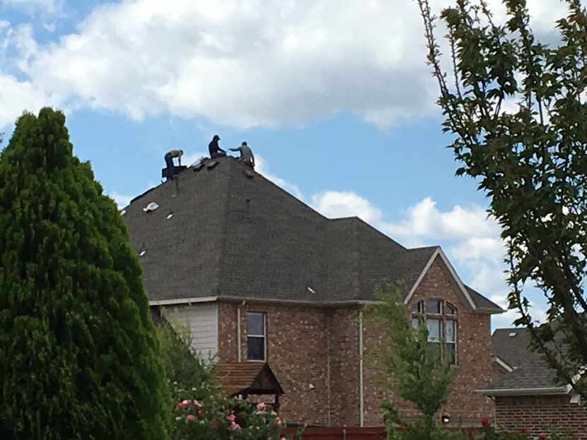 Roofers work in this west Frisco neighborhood where a salesman was shot on April 3.