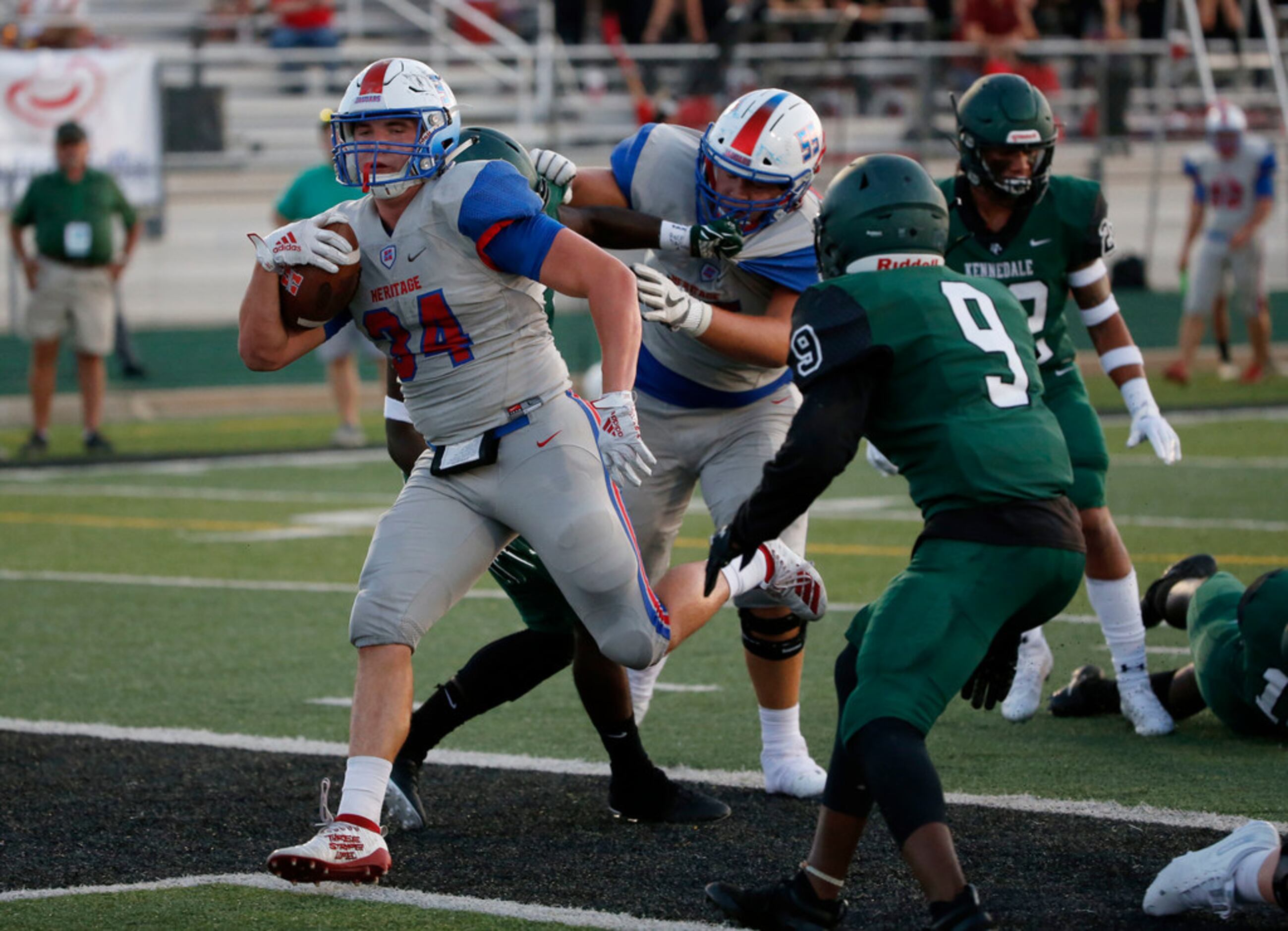 Midlothian Heritage running back Brody Greeson (34) scores a touchdown in front of...