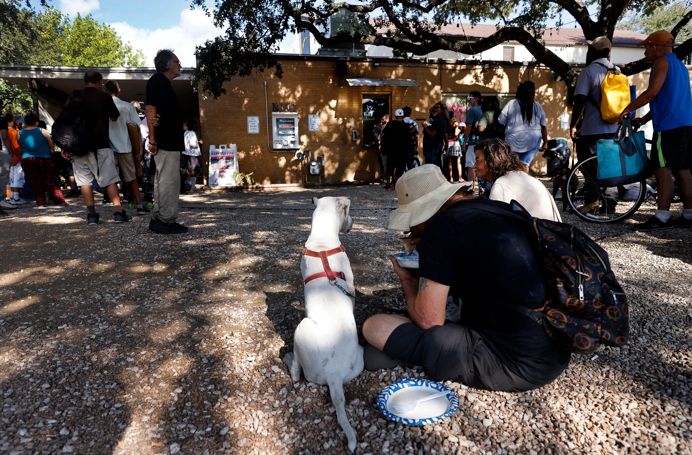 People line up for outreach services at the Sunrise Community Church where a white NICE...