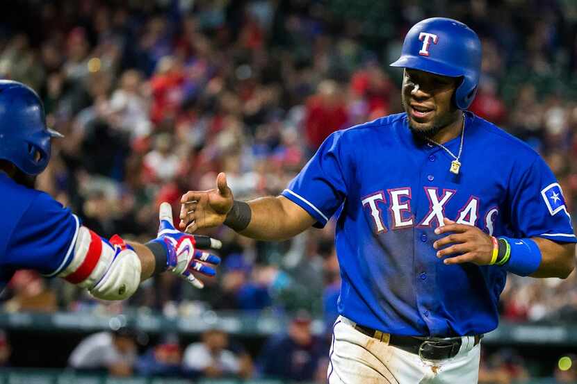 Texas Rangers shortstop Elvis Andrus celebrates after scoring on a passed ball during the...