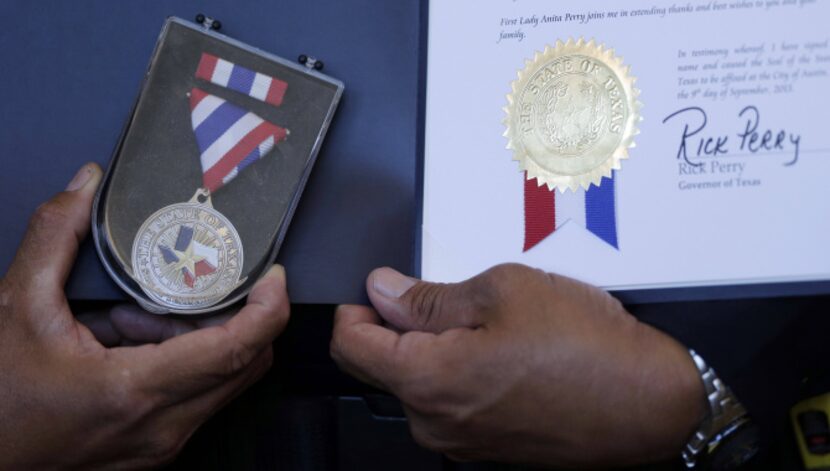 Warrant Officer Jose Esquivel of the Bexar County Sheriff''s Office holds his Star of Texas...