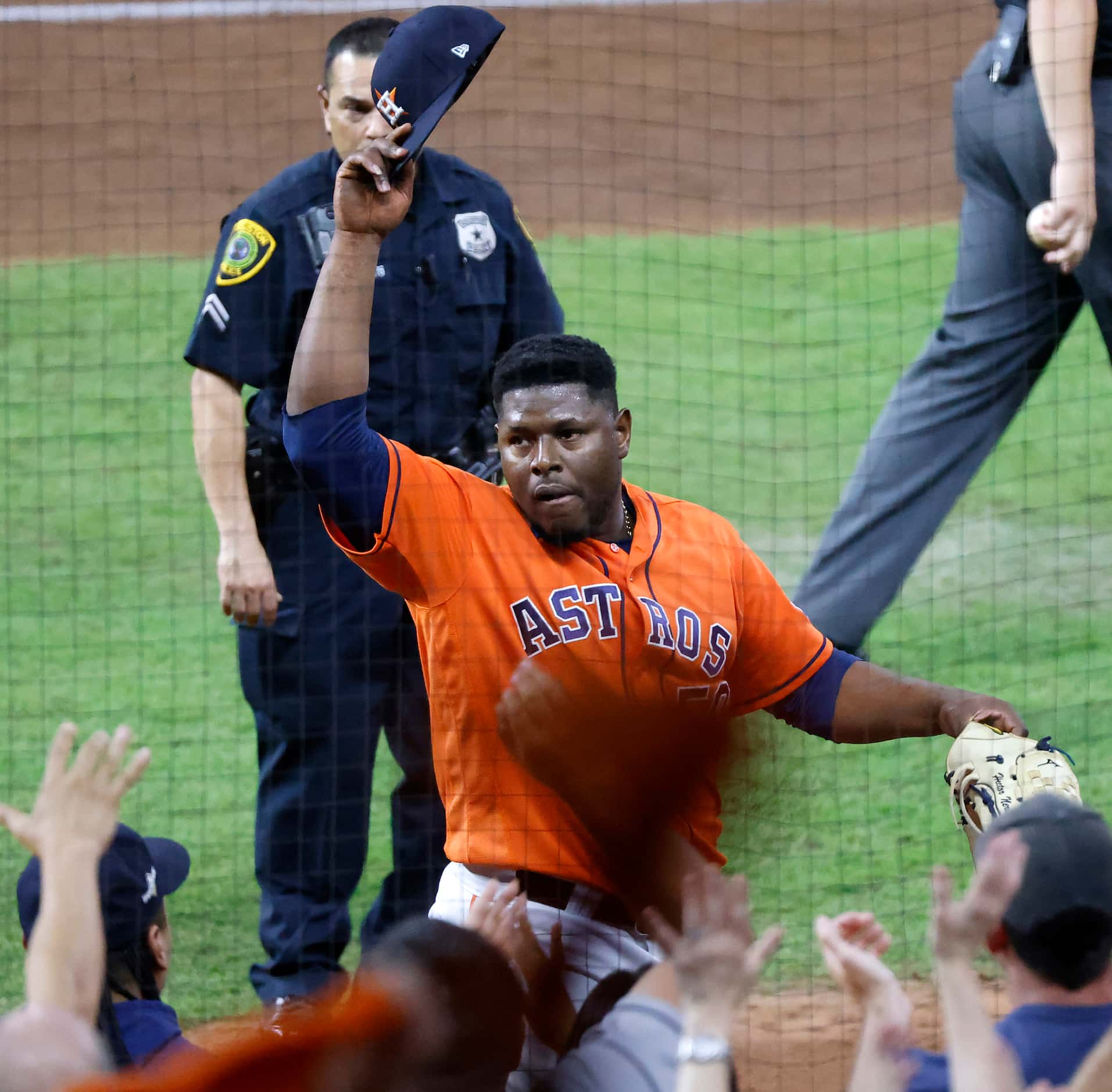 Houston Astros pitcher Hector Neris (50) waves his cap after ending the top of the seventh...