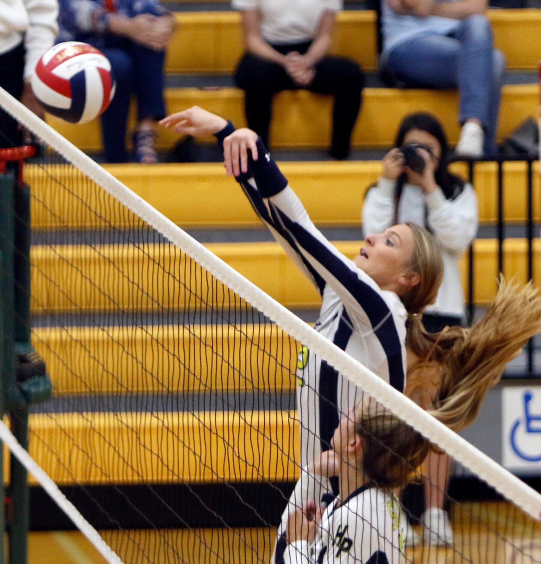 Highland Park outside hitter Kate Nugent (2) rejects a shot at the net by a Carrollton...